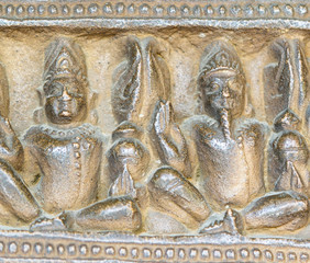 ancient stone sculptures carved into the wall of the temple