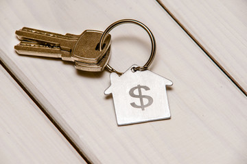 The symbol of the house lies on a white wooden background 