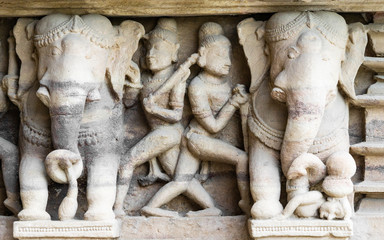 ancient stone sculptures carved into the wall of the temple