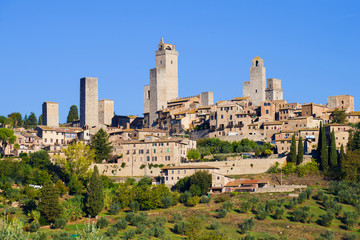 Fototapeta na wymiar City landscape of the medieval town in the sunny September afternoon. San Gimignano, Italy