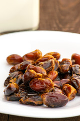 Hushaf - date milk, a traditional dish to Ramadan, cooking, ingredients, dates in a plate and milk in bottles are on the table