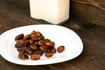 Hushaf - date milk, a traditional dish to Ramadan, cooking, ingredients, dates in a plate and milk in bottles are on the table