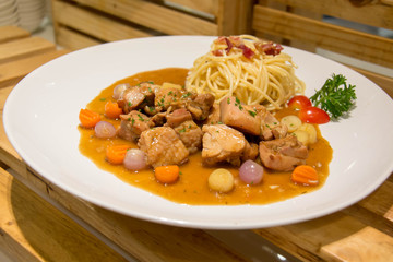  delicious beef stew with spaghetti on plate