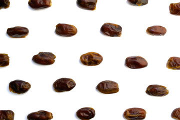sweet dried dates laid out in several rows on a white background