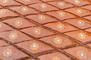 Sweet pie with nuts macro in baked sliced slices. Traditional Middle Eastern cuisine.