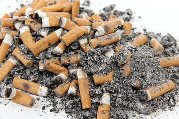 Ashtray and butts sigarette on white background