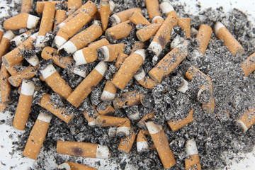 Ashtray and butts sigarette on white background