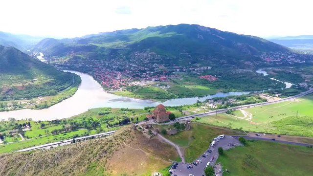 Old georgian Svetitskhoveli Cathedral In Mtskheta with sky and green hills