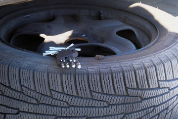 Automobile maintenance concept. Technicians are changing tires. Car service. Changing a flat car tire on road. Close up.