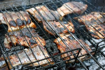 grilled fish in the grill closeup. BBQ