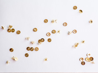 Fototapeta premium metallic pushpins on white paper 