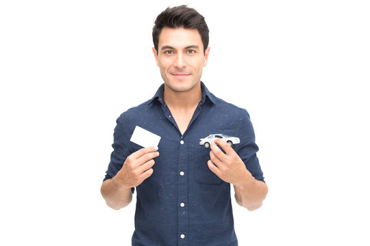 Young Caucasian Man Holding Car Insurance Card Isolated On White Background