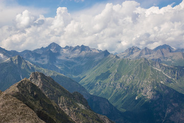 Naklejka premium Panorama of mountains scene with dramatic cloudy sky in national park of Dombay
