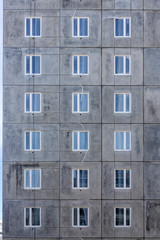 Background of windows wall of panel box building of cheap housing