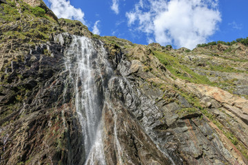 Fototapeta na wymiar Panorama view of waterfall scene in mountains, national park of Dombay, Caucasus