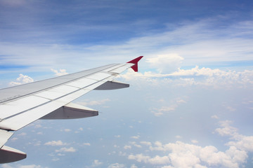 Fototapeta na wymiar airplane wing look from airplane window above the sky