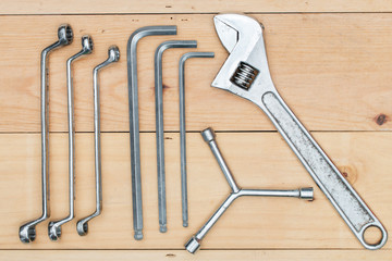 Wrench tool on wooden background.