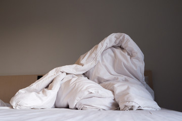 Fototapeta na wymiar a white corrugated blanket on the bed