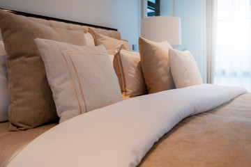 Bed maid-up with clean white pillows and bed sheets in beauty bedroom. Close-up. interior background