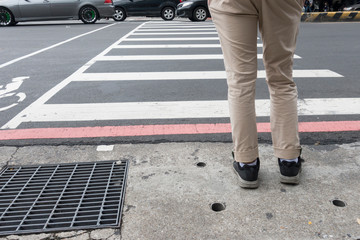 Fototapeta premium A man is waiting to cross the road