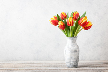 Fresh red-yellow tulips in a jug