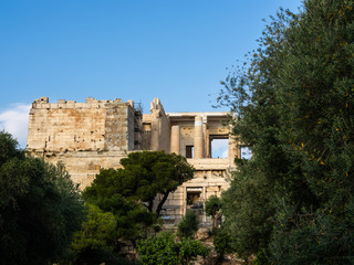 Fototapeta na wymiar View of Propylaea entrance to Acropolis area on Athens, Greece against clear blue sky and greenery