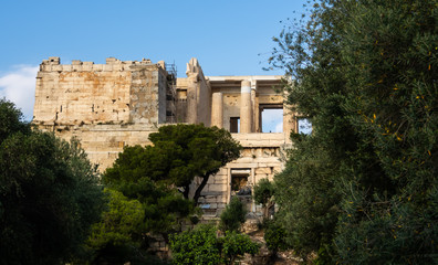 Fototapeta na wymiar View of Propylaea entrance to Acropolis area on Athens, Greece against clear blue sky and greenery