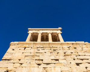 Fototapeta na wymiar View from below of Temple of Athena Nike in Acropolis area of Athens, Greece