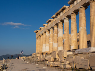 Columns of Parthenon temple on Acropolis, Athens, Greece at sunset against blue sky