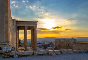 View of Erechtheion on Acropolis, Athens, Greece, against sunset overlooking the city