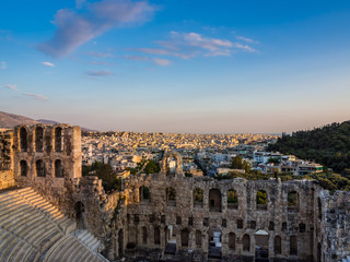 Fototapeta na wymiar View of Odeon of Herodes Atticus theater on Acropolis hill, Athens, Greece, overlooking the city at sunset