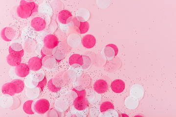 Flatlay of Colorful Round Paper Confetti on pink Paper. Top view