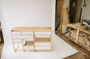 Handmade wooden table with drawers on white background