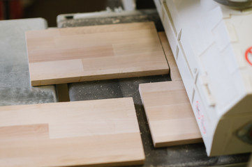 The master works on a surface grinding machine in the carpentry workshop