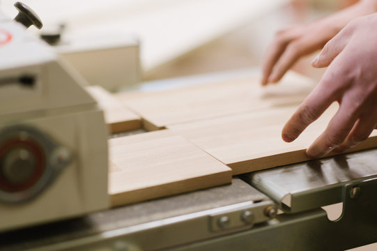 The master works on a surface grinding machine in the carpentry workshop