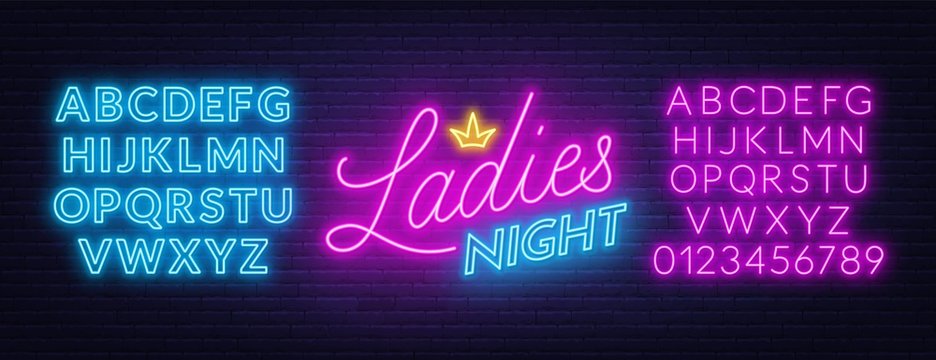 Ladies Night neon lettering on brick wall background.