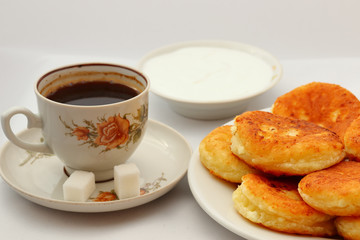 Fragrant ruddy golden with a brown crust freshly cooked syrup curds(cheesecake) with strawberry jam and sour cream piping hot.