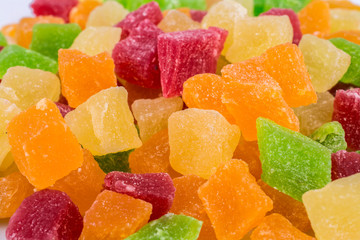 Background of candied fruit in various colors close-up.