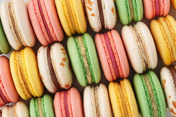 Rows of colorful french macarons. Creative background.