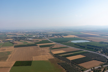 Fototapeta na wymiar Mount Tabor in the Lower Galilee region of Northern Israel rises with its distinctive shape from the flat and fertile Jezreel Valley. Mount Tabor is important as a Biblical site