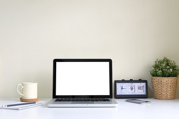 Office desk Workspace stuff with notepad, laptop and coffee cup mouse notepad shot.