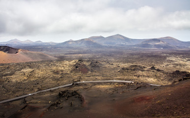 view of a volcanic landscape with lava and some plants on the island of lanzarote similar to the lunar aspect
