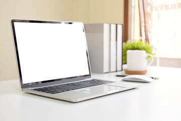 Fototapeta premium Workspace desk and mockup laptop. copy space and blank screen. Business image, Blank screen laptop and supplies.