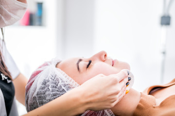 Obraz na płótnie Canvas Beautician cleanses skin woman with sponge in spa beauty salon. cosmetology treatment skincare face