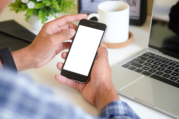 Cropped shot view of man hands holding smart phone with blank copy space screen for your text message or information content, female reading text message on cell telephone during in urban setting.