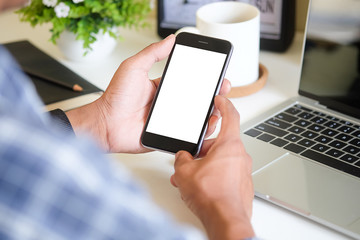 Cropped shot view of man hands holding smart phone with blank copy space screen for your text message or information content, female reading text message on cell telephone during in urban setting.