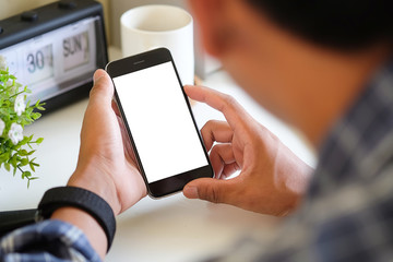 Cropped shot view of man hands holding smart phone with blank copy space screen for your text message or information content, female reading text message on cell telephone during in urban setting.