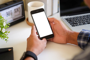 Cropped shot view of man hands holding smart phone with blank copy space screen for your text message or information content, female reading text message on cell telephone during in urban setting.