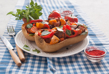 Stuffed pumpkin Butternut meat and vegetables homemade blue tablecloth. The concept of healthy eating.