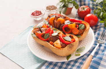 Stuffed pumpkin Butternut meat and vegetables homemade blue tablecloth. The concept of healthy eating. Copy space.